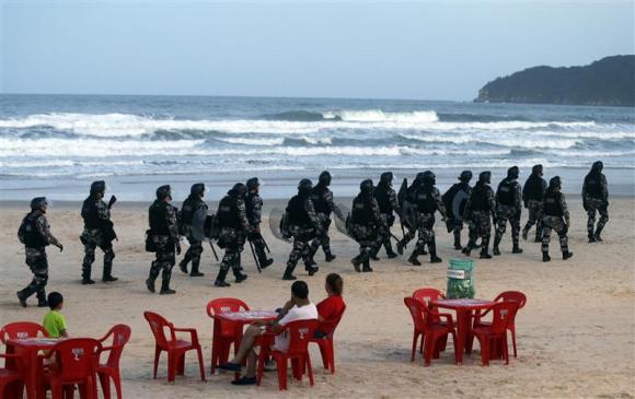 Riot police patrol the Santinho beach next the Costao do Santinho hotel ahead of the 2014 FIFA World Cup in Florianopolis