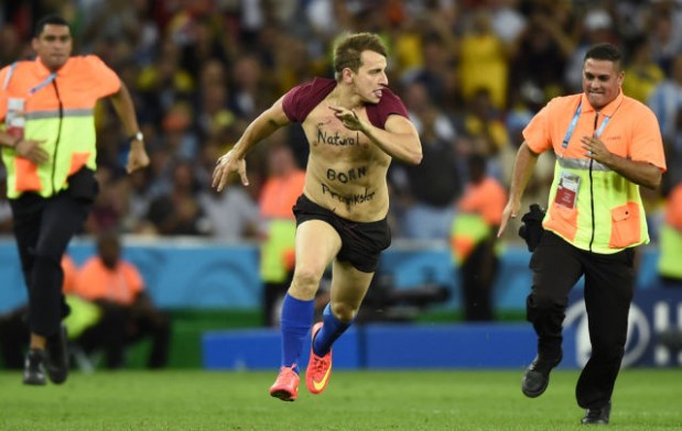 Stewards chase a fan off the pitch during the 2014 World Cup final between Germany and Argentina in Rio de Janeiro