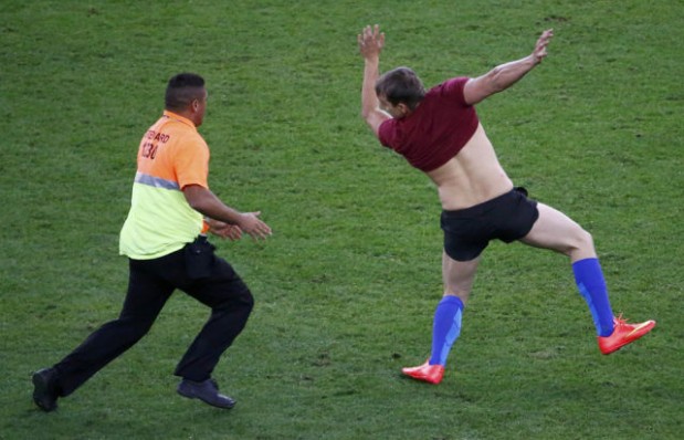 A steward chases a supporter who entered the pitch during the 2014 World Cup final between Germany and Argentina at the Maracana stadium in Rio de Janeiro