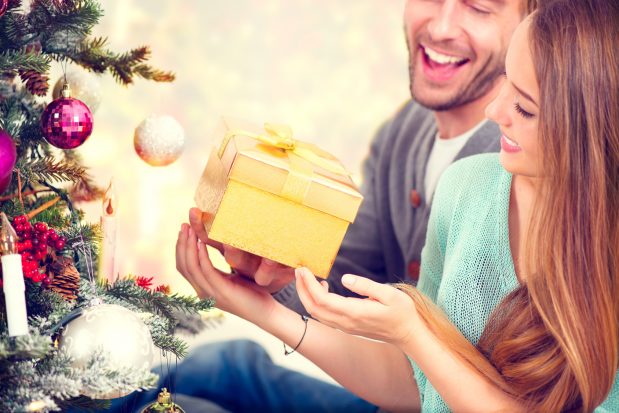 Happy Couple with Christmas Gift at Home