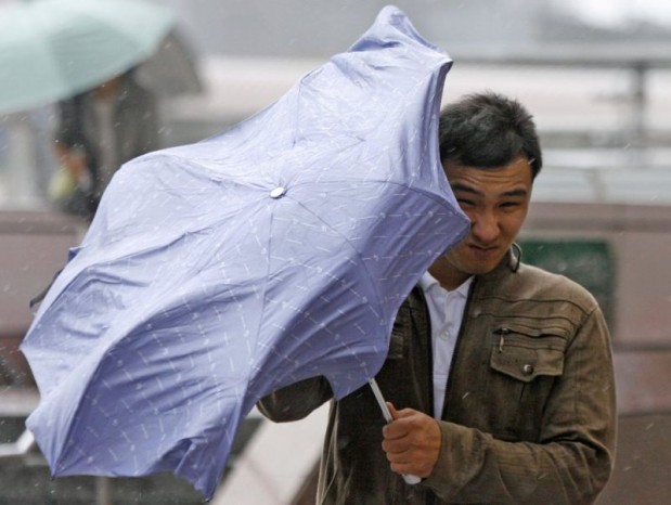 Pedestrian struggles with an umbrella in strong winds brought about by Typhoon Parma in Taipei