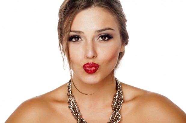 beautiful young woman with pursed lips and a necklace