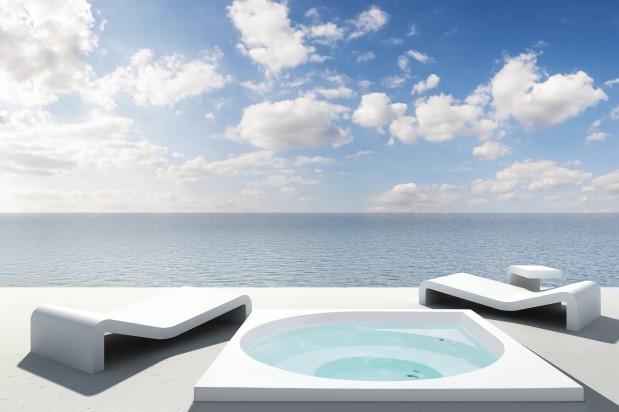 Mondern white sunbeds on a  terrace with ocean view. 3d render.